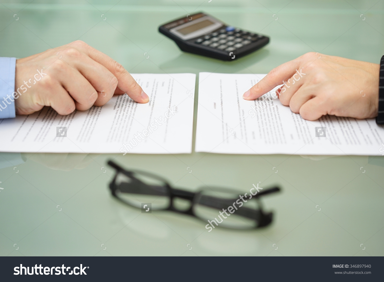 Stock photo man and and woman are reading slowly insurance policy 